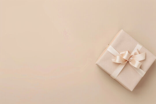 A minimalist image featuring gift box on the right. The gift is wrapped in pastel paper with a ribbon bow, against a solid, neutral background with empty space on the left
