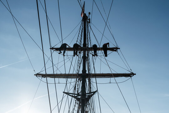 Sailors Climbing Rigging on Tall Ship - Powered by Adobe