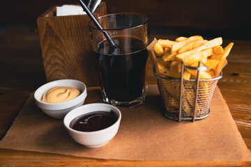 French fries and a glass of soda. Fast food. Cafe
