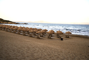 Beach chair and umbrella on sand beach near hotel