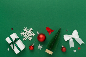 Small christmas tree with decor on color background, top view