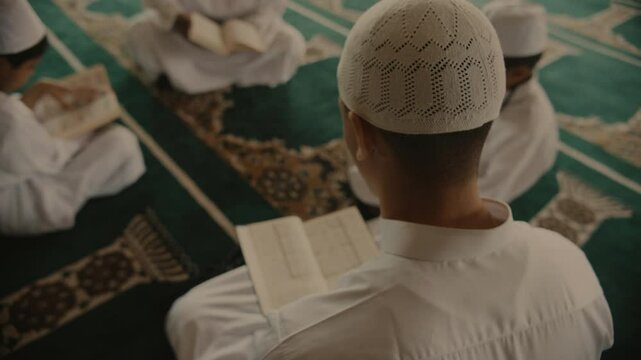 Muslim family praying and reading from books
