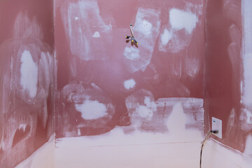 Repairing damaged walls in home by putting tying them