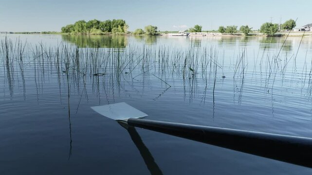hatchet sculling oar on a calm lake, Boyd Lake in Colorado
