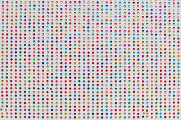 Multicolored rhinestones close-up on a white background. Preparation for the holiday. Children's...