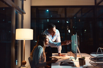 Night, talking or business people on computer for coaching in office for teamwork, partnership or collaboration. Learning, education and editor teaching woman editing for feedback, review or project