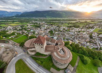 Vaduz Castle in Liechtenstein. Picturesque view of fairytale castle in Alps mountains at Sunset Time. A Landmark Aerial © Oleksandr