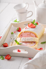 Tasty and fresh strawberry roulade as fresh summer cake.