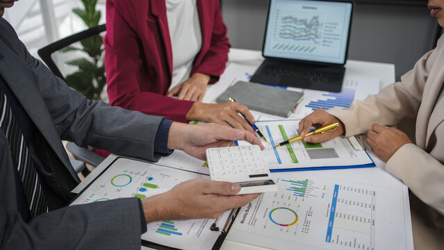 Businesspeople in an office meeting, analyzing financial data, collaborating on marketing strategies. Diverse team brainstorming solutions for investment growth