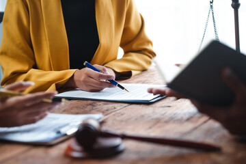 Lawyer explaining a contract in an office meeting, clients listening attentively, discussing legal...