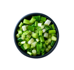 Chopped spring onions in a black ceramic bowl isolated on white background. Top view.