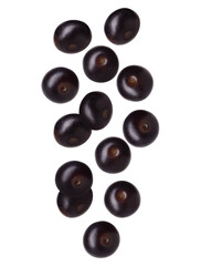 Many acai berries falling on white background