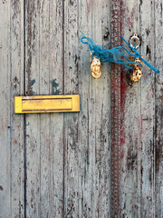 old wooden door with lock and golden postbox on the camino de santiago in portugal, the portuguese way, pilgrimage along the St James way