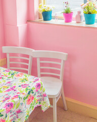 Table for two chairs at pink diner cafe in San Francisco, California