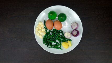 Assortment of Fresh Cooking Ingredients Including Egg, Onion, Green Chili, Coriander Leaves, Cucumber, Tomato, Cabbage, Potato, Bread, Noodles, Sugar, Jackfruit, Carrot, Garlic, Ginger, Lemon