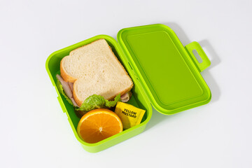 sandwich with ham inside a lunch box, to go meal
