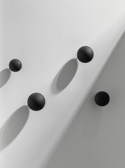 A minimalist composition of dark metal spheres on a white background with shadow effects.Flat lay 