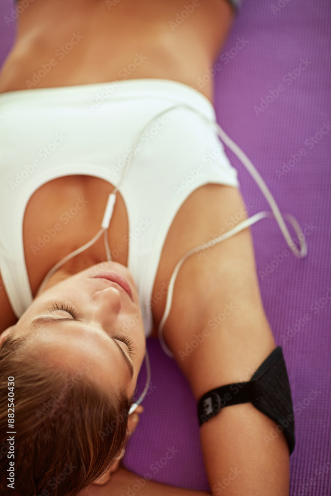 Poster Woman, earphones and lying on floor for workout break or rest with exercise and fitness. Female person, home and tired with music or audio sound to relax for wellness, wellbeing and self care