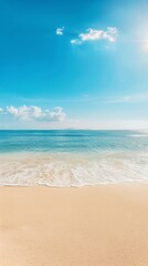 Fototapeta premium Serene Seaside Beach with Gentle Waves, Golden Sand, and Clouds under Bright Sunlight - Tranquil Coastal Scene