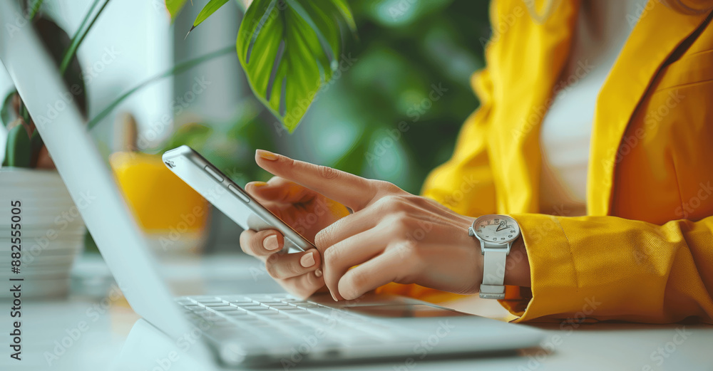 Poster close up of woman's hands using smartphone while working in modern office with keyboard and yellow b