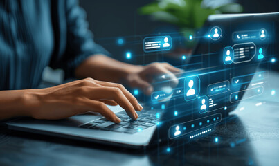 Business Woman Using Laptop with Virtual Display Showing Chat App Icons and Transferring Information to Mobile Phone for Online Work with Chatbot Assistance and CRM Technology