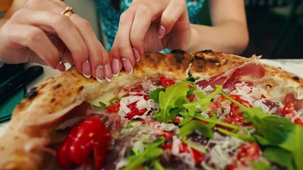 Witness crafting gourmet pizza in a professional kitchen through detailed 4K view of expert hands in action