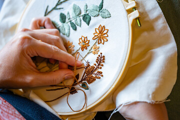 Woman's hands working on embroidery with thread and needle
