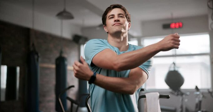 Happy man, fitness and stretching with arms at gym for workout, exercise or training. Young and active male person in body warm up, preparation or getting ready for wellness at indoor health club