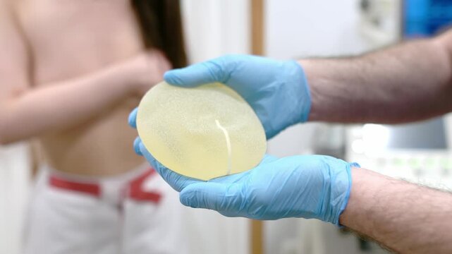 A young woman at a mammologist's appointment. Consultation on breast shape correction - lifting, reduction, reconstruction, enlargement, implants. Breast cancer awareness. Cosmetic Plastic Surgery