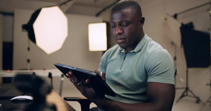 Black man, photographer and production on tablet in studio for editing photoshoot pictures, digital art or retouch process. Male editor, backstage and software for photography catalog for magazine