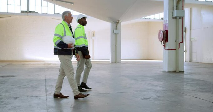 Man, architect and walking with blueprint at site for construction, planning or inspection. Male person, team or civil engineer in discussion for building project, industrial architecture or contract