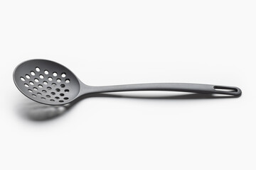 A skimmer, kitchen utensils, a large round spoon with holes. Close-up on white.