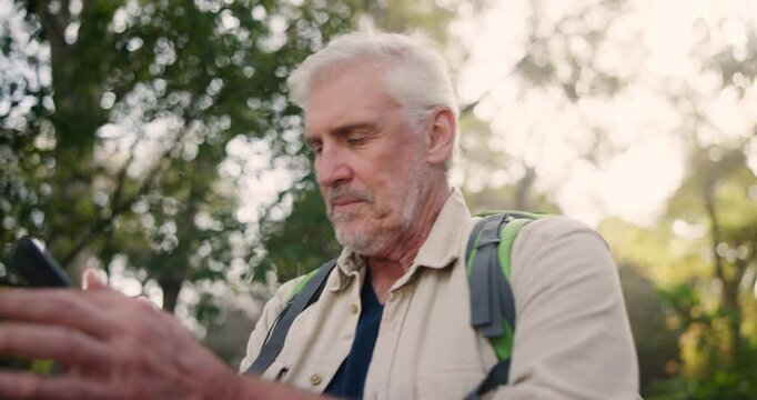 Man, hiking and phone with lost signal in outdoor for connect, trekking and backpacking in forest with reception error. Angry, mature person and travel for poor location, adventure or survivor