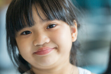 A six-year-old Malaysian girl enjoying an early summer afternoon at a stylish cafe in Selangor, Malaysia.