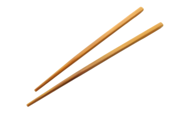 Pair of wooden chopsticks isolated on white background. Essential for enjoying Asian cuisine. Perfect for culinary, kitchen, and tableware themes.