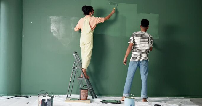 Back, couple and renovations with painting on wall in new home or house for diy or makeover. People, relationship and love with fun to enjoy, support and care for teamwork, collaboration and decorate