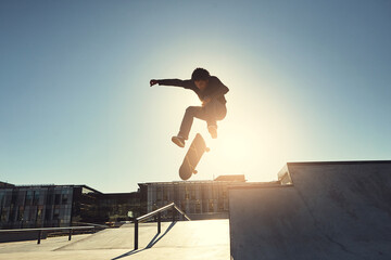 Skateboard, man and jumping in urban skate park with trick and training in Los Angeles with speed....