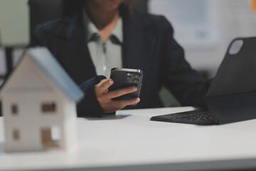 Real estate agents explain models of housing estates in projects to elaborate to clients,...