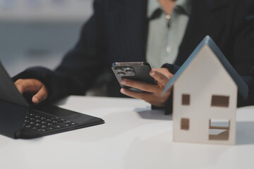 Real estate agents explain models of housing estates in projects to elaborate to clients,...