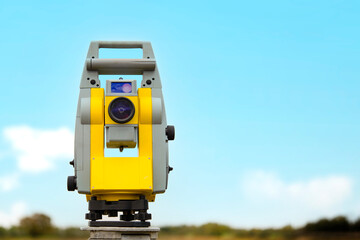 Yellow And Gray Theodolite Surveying Instrument In   Field On   Sunny Day