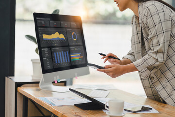 Businesswoman working and calculating on digital financial dashboard, planning business growth,...