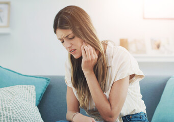 Home, sofa and woman with toothache or mouth in pain for dental problem and discomfort of cavity....