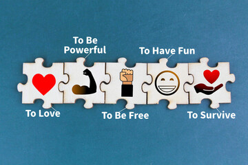 wooden puzzle with icons to love and belong, to be powerful, to be free, to have fun and to...
