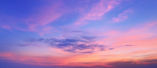 Obraz premium Pink and Blue Sunset Sky with Clouds