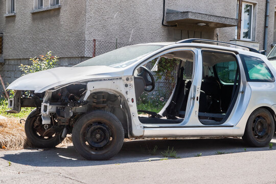 Dismembered car on country street closeup on sunny day