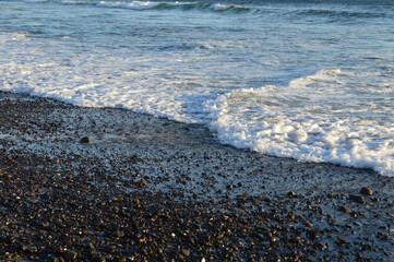 Sunlit Rocks and Water's Edge