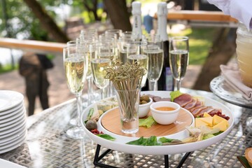 Delectable treats and sparkling beverages on a table by the riverbank.