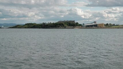 BURNTISLAND, FIFE, SCOTLAND, UK - JUNE 11, 2024: A view of Burntisland Leisure Centre, showing the calm waters, greenery and clouds