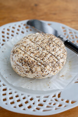 French fresh white soft goat cheeses with topping made with black pepper