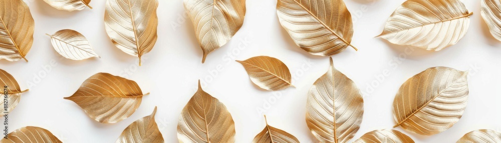Aufkleber golden leaves scattered on a white background, creating a minimalistic and elegant autumn-themed com